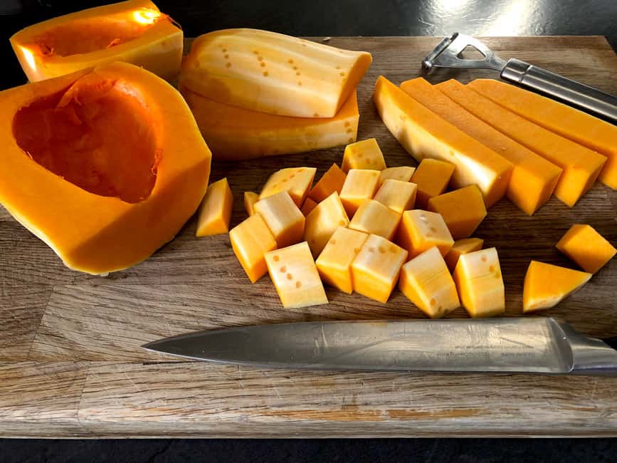 Peeled and segmented butternut squash cut to cubbes.