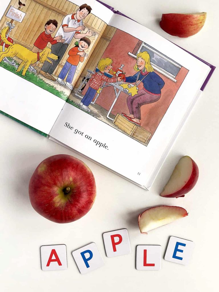 a book, apple and letters