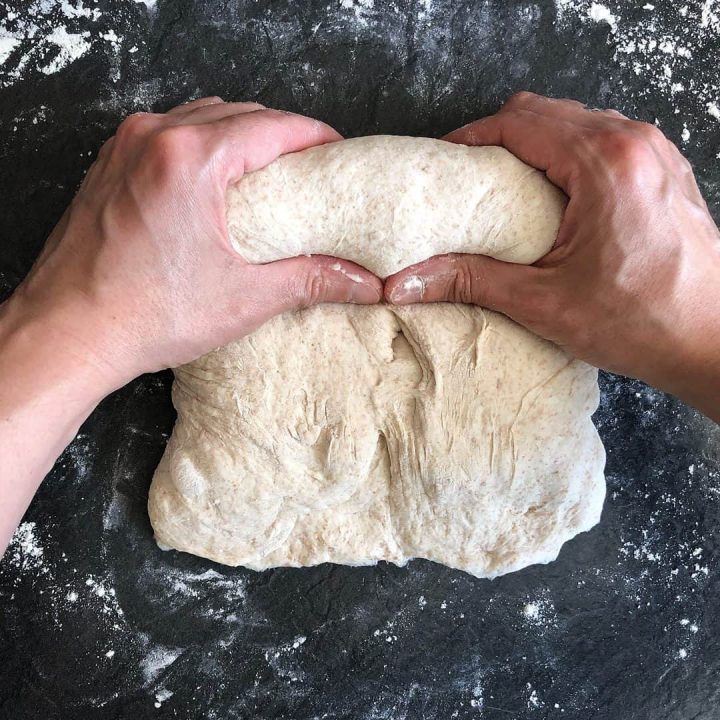 shaping sourdough for a loaf tin