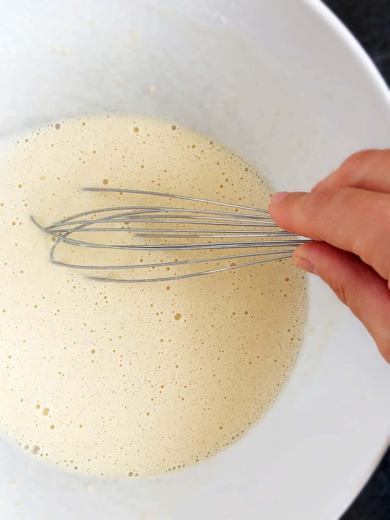 pancake batter in a bowl with a balloon whisk