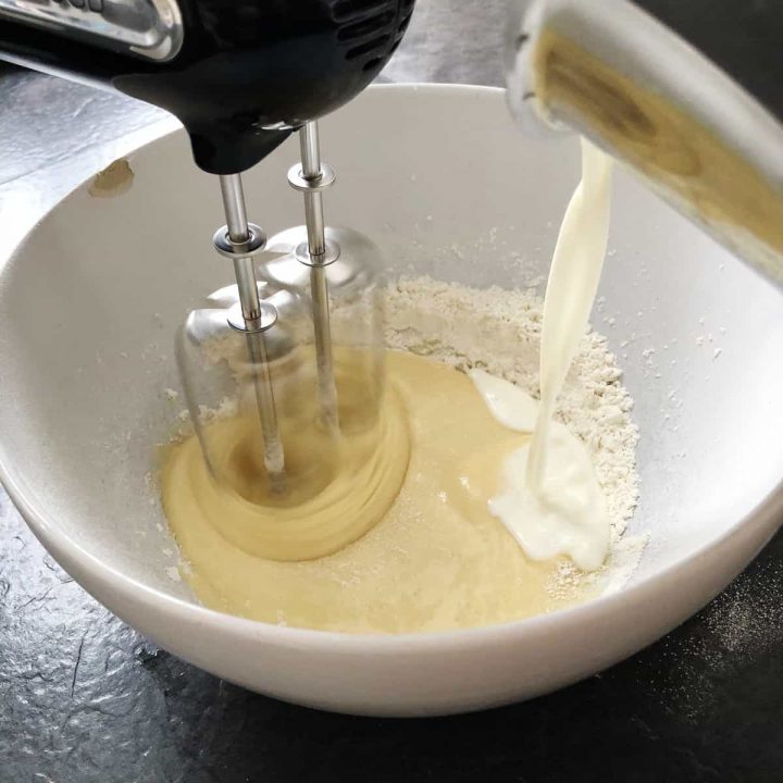 pouring milk into the flour